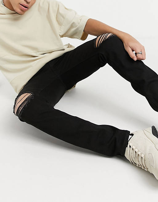 ASOS DESIGN skinny jeans in black with knee rips