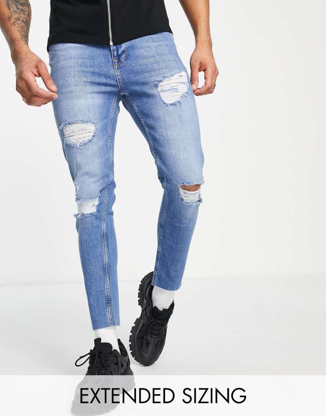 ASOS DESIGN skinny jeans in dark wash blue with heavy rips