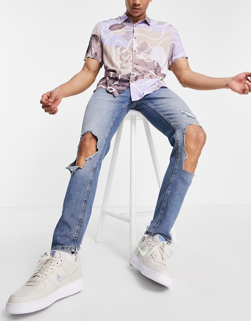ASOS DESIGN skinny jeans in light wash blue with extreme rips-Blues