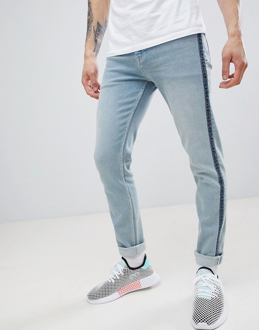 Asos Design Skinny Jeans In Light Wash Blue With Geo-tribal Taping In White
