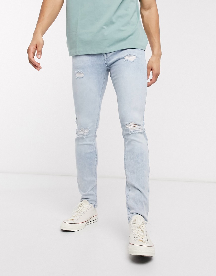ASOS DESIGN skinny jeans in light wash blue with knee rips