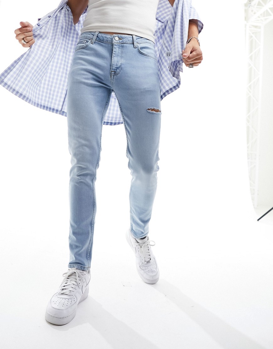 ASOS DESIGN skinny jeans in light wash blue with thigh rip