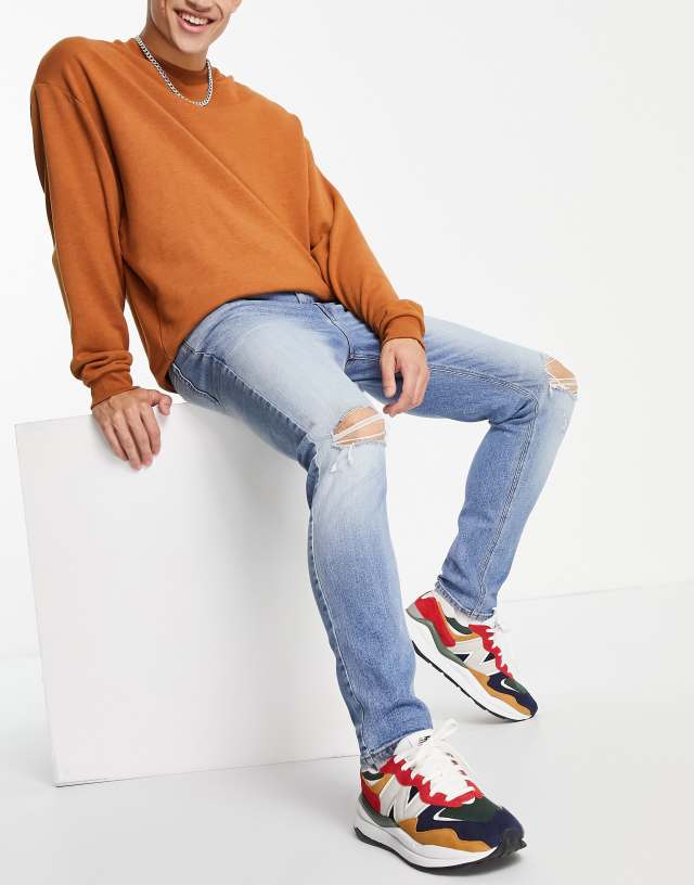 ASOS DESIGN skinny jeans in light wash with knee rips