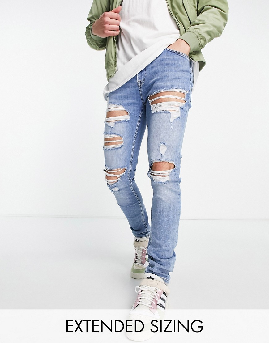 ASOS DESIGN skinny jeans in mid blue with heavy rips