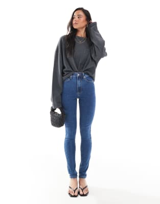 Asos Design Skinny Jeans In Mid Blue