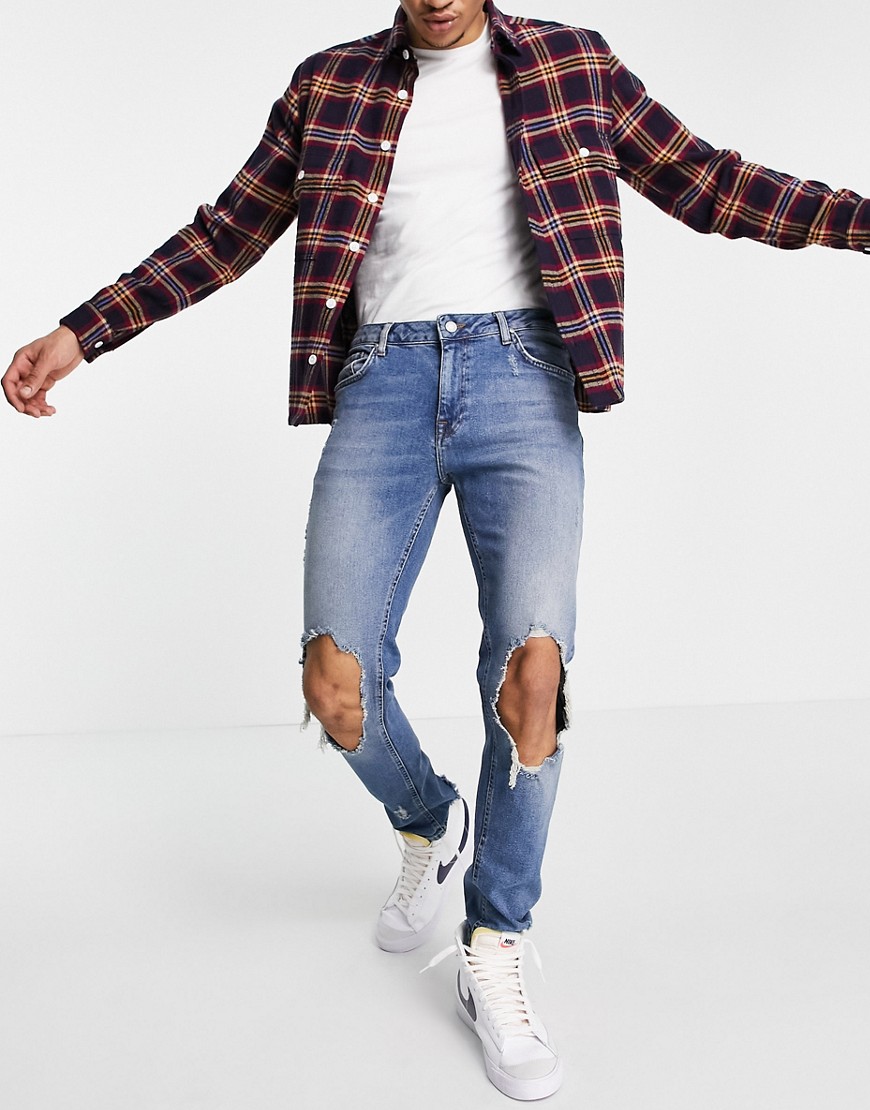 ASOS DESIGN skinny jeans in mid wash blue with extreme rips-Blues