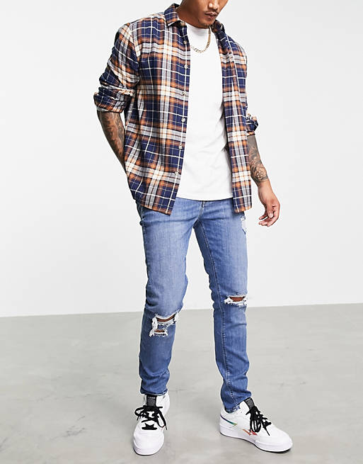 ASOS DESIGN skinny jeans in mid wash blue with knee rips