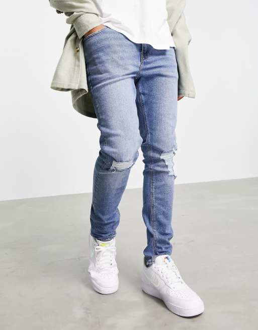 Asos Design Skinny Jeans In Mid Wash Blue With Knee Rips Asos 