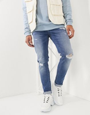 ASOS DESIGN skinny jeans in mid wash blue with rips and destroy | ASOS