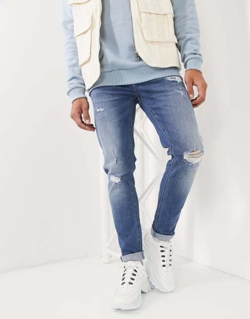 ASOS DESIGN skinny jeans in mid wash blue with rips and destroy