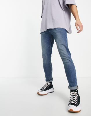 ASOS DESIGN skinny jeans in mid wash blue | ASOS