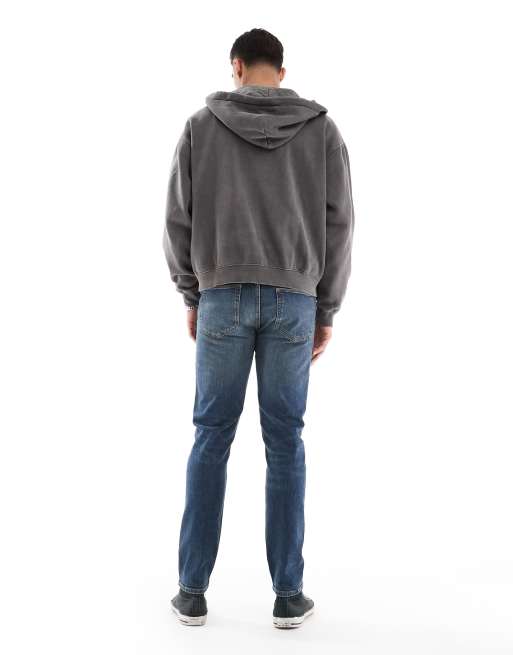 ASOS DESIGN skinny jeans in mid wash blue