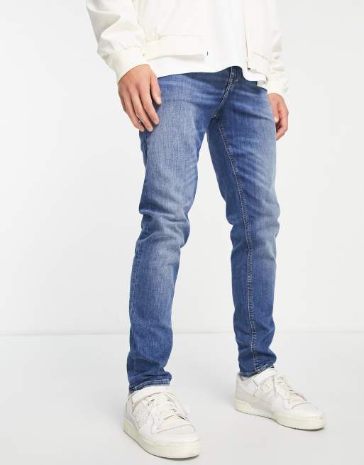 ASOS DESIGN skinny jeans in mid wash blue | ASOS