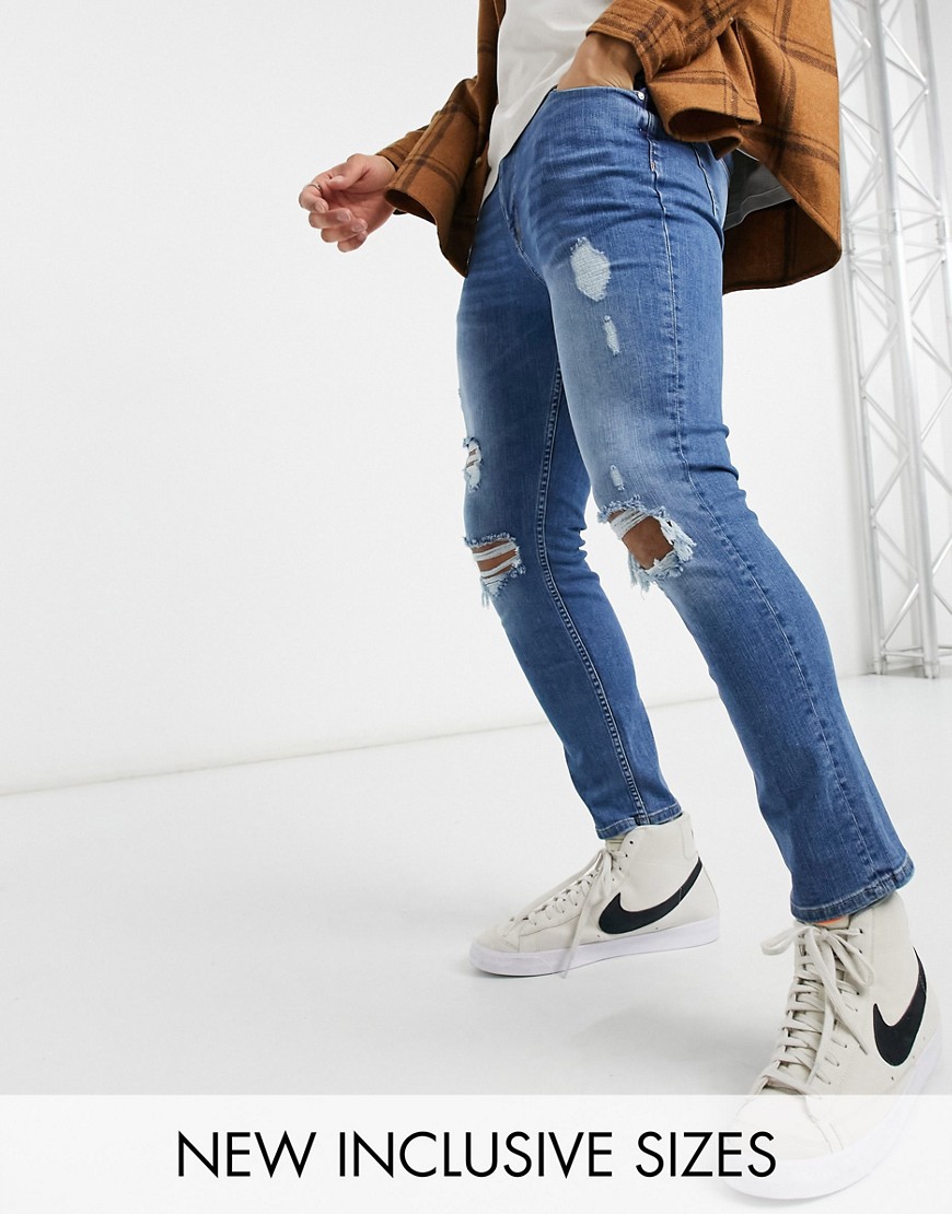 ASOS DESIGN skinny jeans in mid wash with heavy rips-Blues