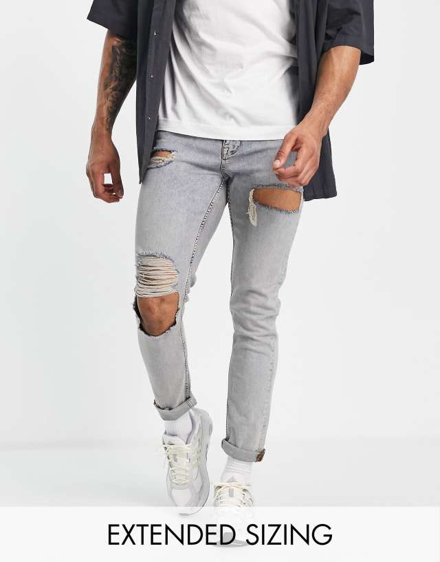 ASOS DESIGN skinny jeans in mid wash with heavy tint and thigh rip