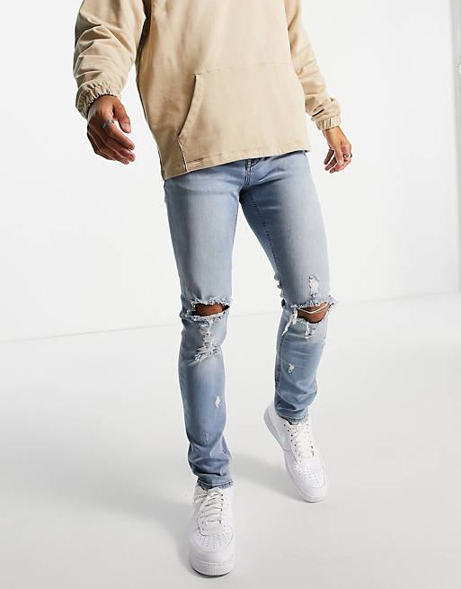 ASOS DESIGN skinny jeans in mid wash with knee rips