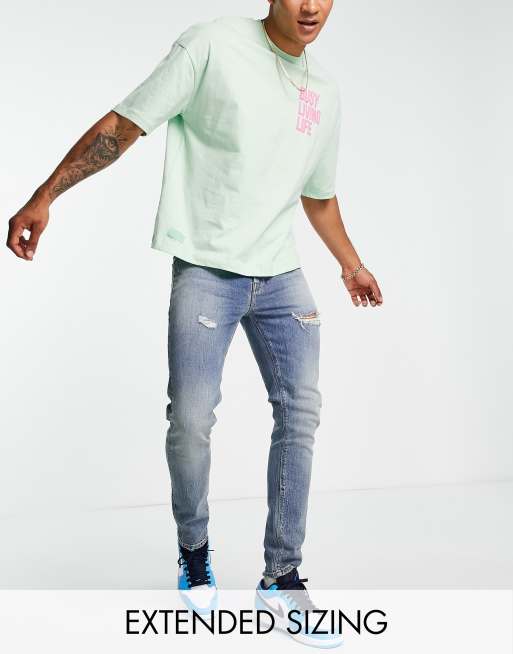 ASOS DESIGN skinny jeans in mid wash with rips