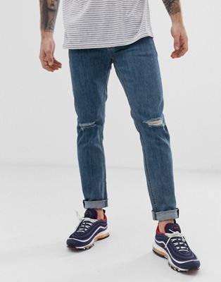 ASOS DESIGN - Skinny jeans in middenblauw met scheuren op de knie
