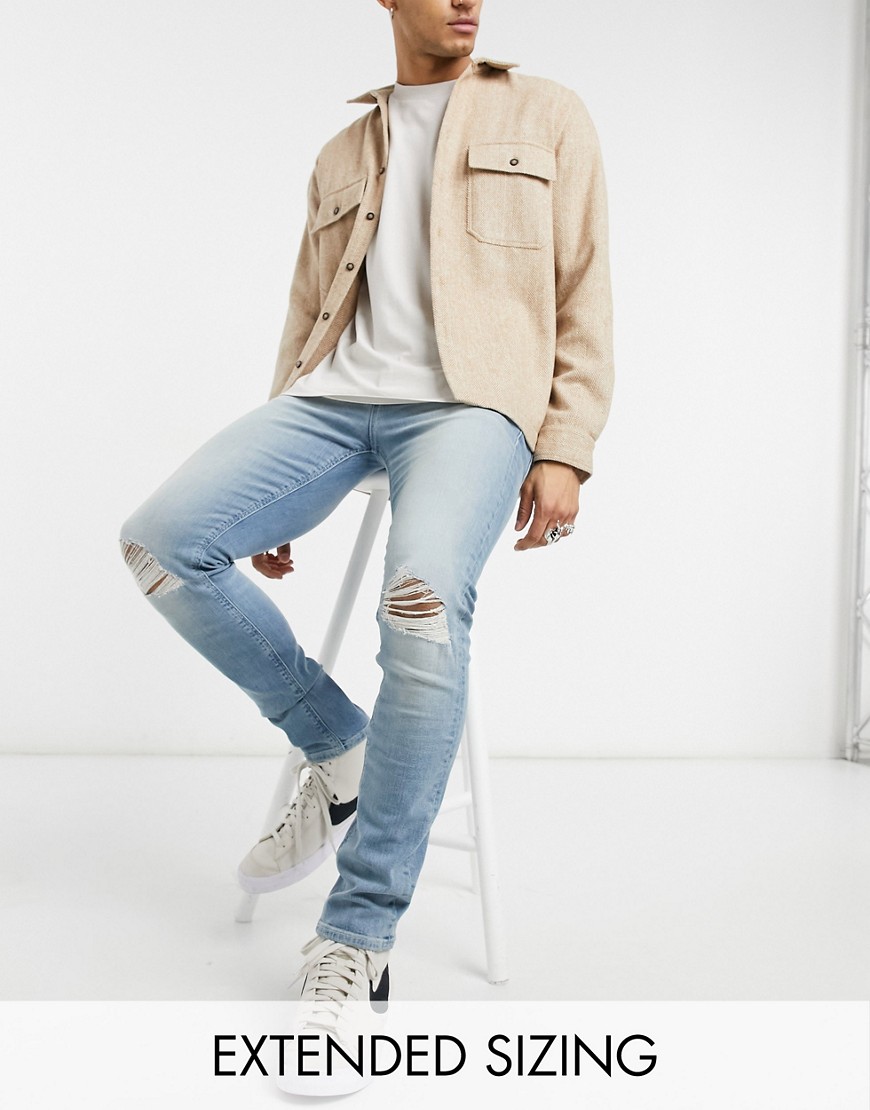 ASOS DESIGN skinny jeans in vintage light wash blue with knee rips-Blues