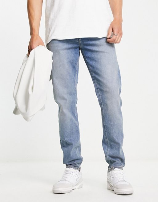 ASOS DESIGN stretch tapered jeans in retro mid wash blue