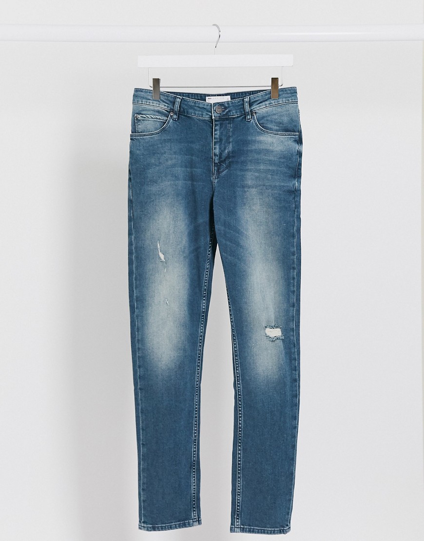 ASOS DESIGN skinny jeans in vintage mid wash tint with abrasions-Blue