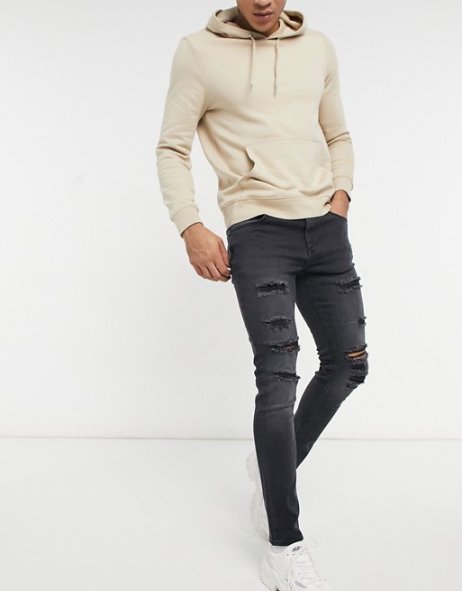 ASOS DESIGN skinny jeans in washed black with thigh rip