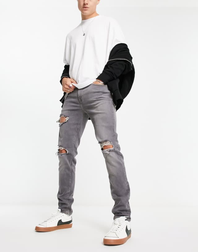 ASOS DESIGN skinny jeans in washed gray with heavy rips