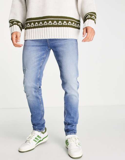 ASOS DESIGN - Skinny jeans met slijtplekken in blauwe mid  wash