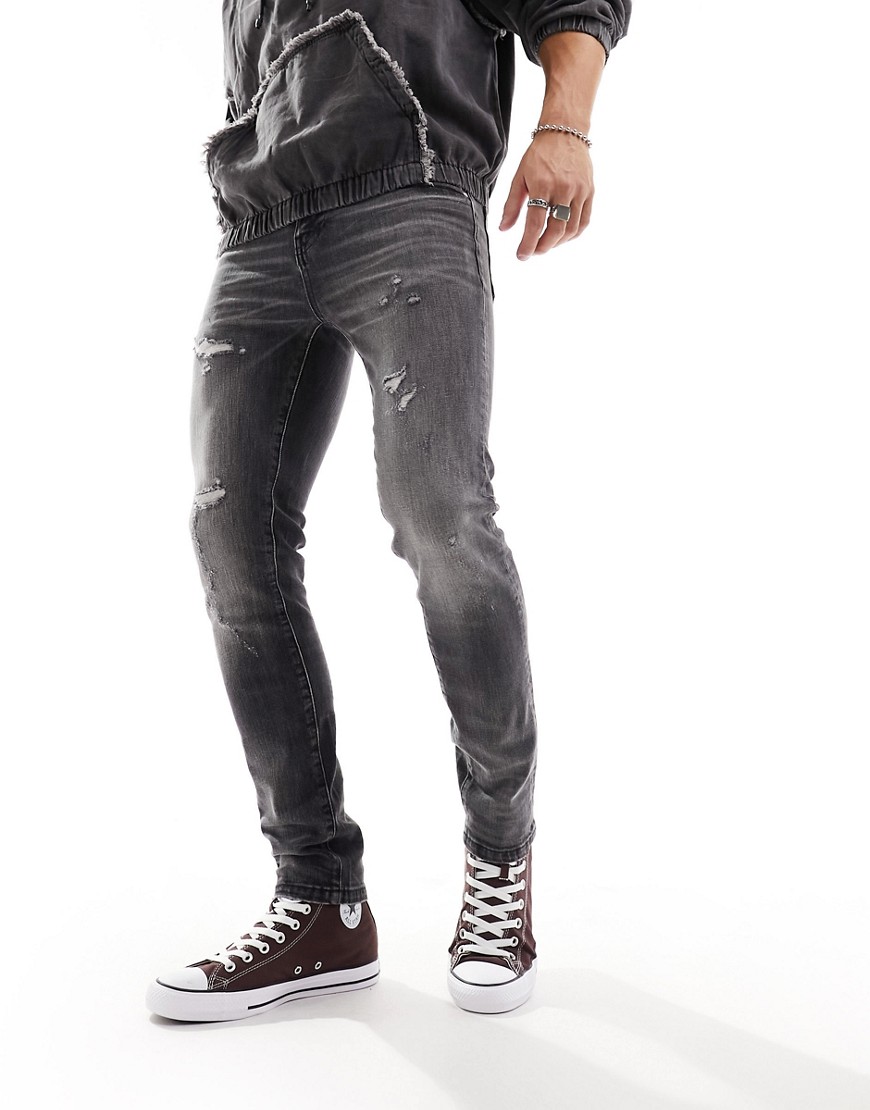 ASOS DESIGN skinny jeans with abrasions in vintage washed black
