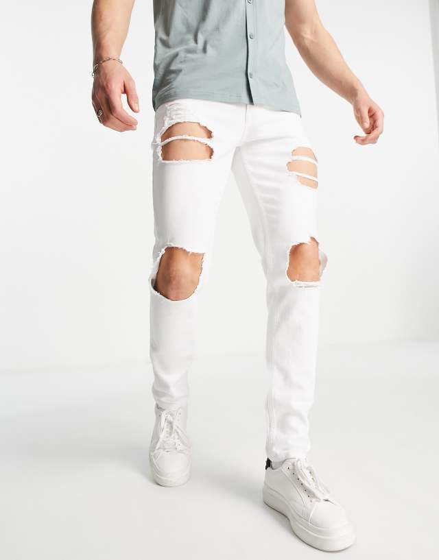 ASOS DESIGN skinny jeans with heavy rips in white