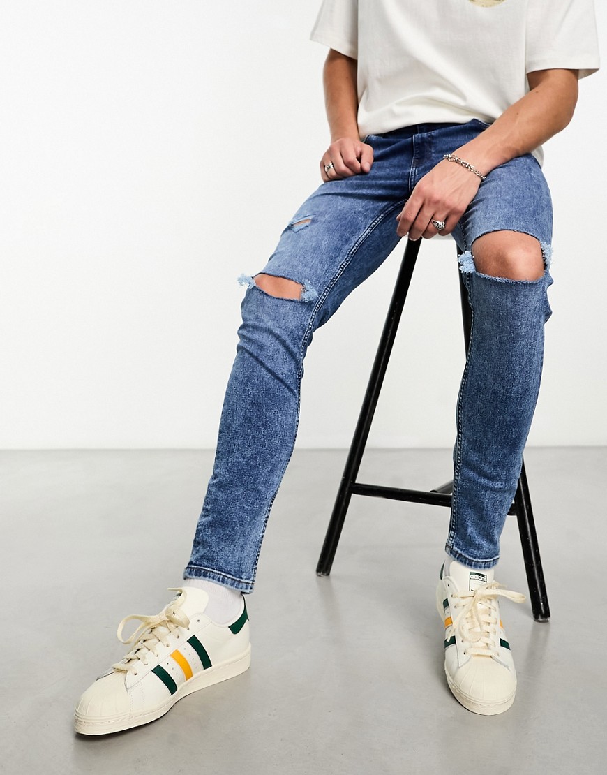 ASOS DESIGN skinny jeans with knee rips in mid wash blue