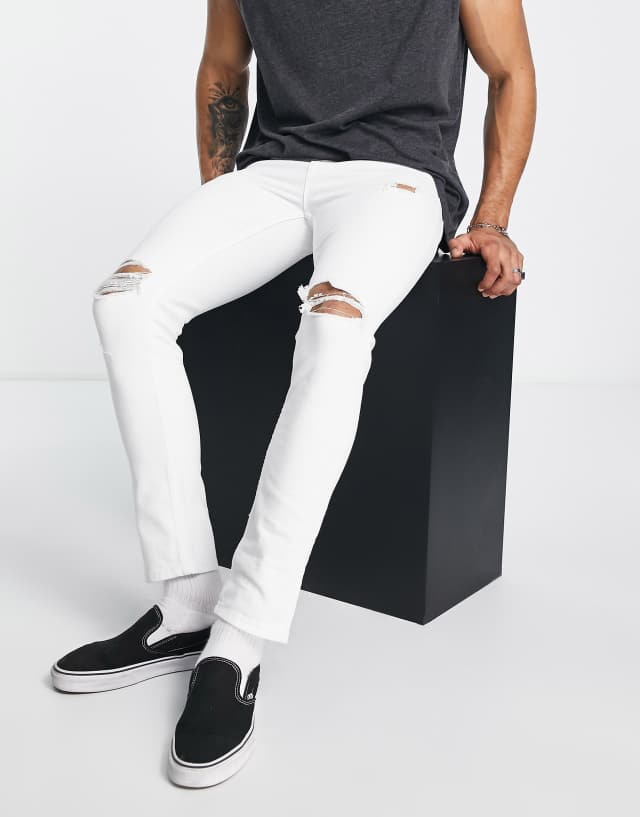 ASOS DESIGN skinny jeans with knee rips in white