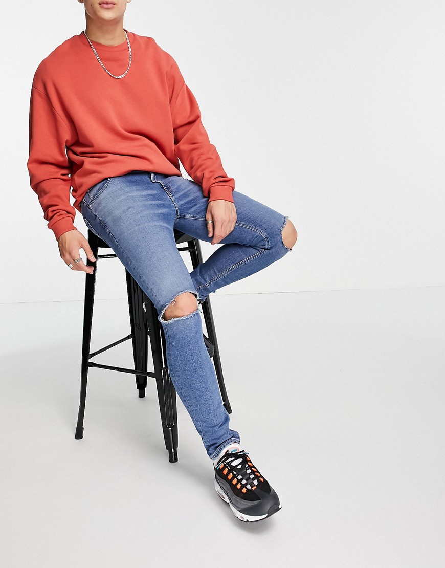 ASOS DESIGN SKINNY JEANS IN MID BLUE WITH KNEE RIPS - MBLUE-BLUES,SK ZYME