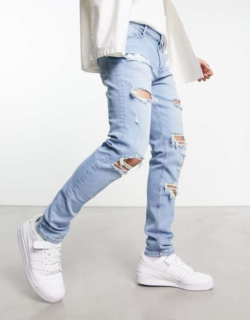 ASOS DESIGN skinny jeans with rips in light wash blue