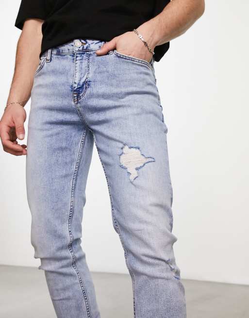 ASOS DESIGN skinny jeans with rips in light wash blue