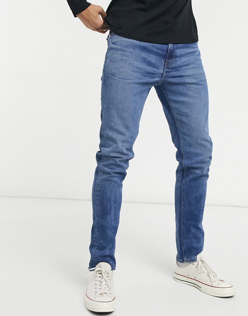 ASOS DESIGN skinny jeans with sustainable 'less thirsty' wash in dark blue