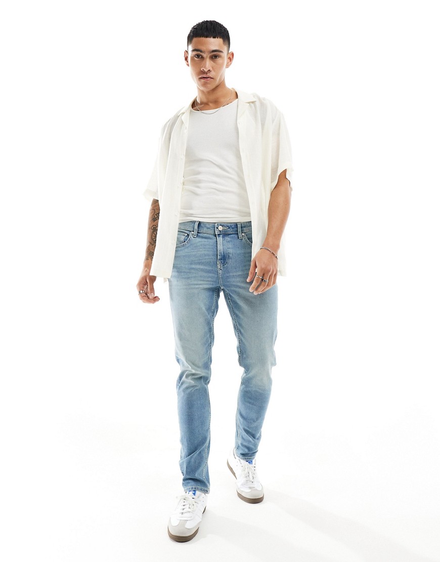 ASOS DESIGN skinny jeans with tint in light wash blue