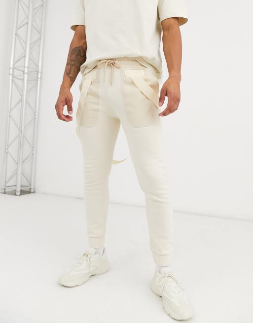 ASOS DESIGN skinny jersey joggers with straps in off white utility