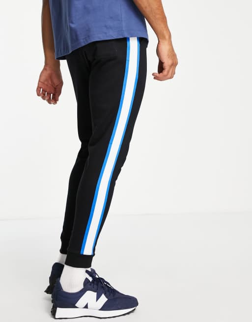 ASOS DESIGN skinny joggers with side stripe in black