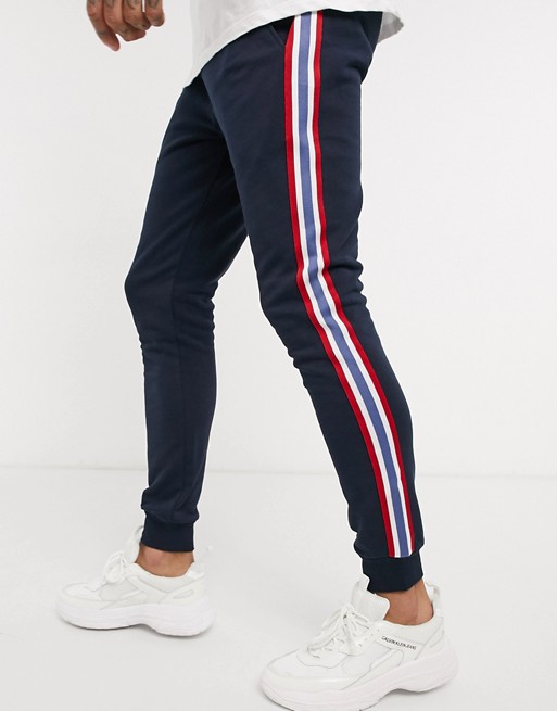 ASOS DESIGN skinny joggers with side stripe taping in navy