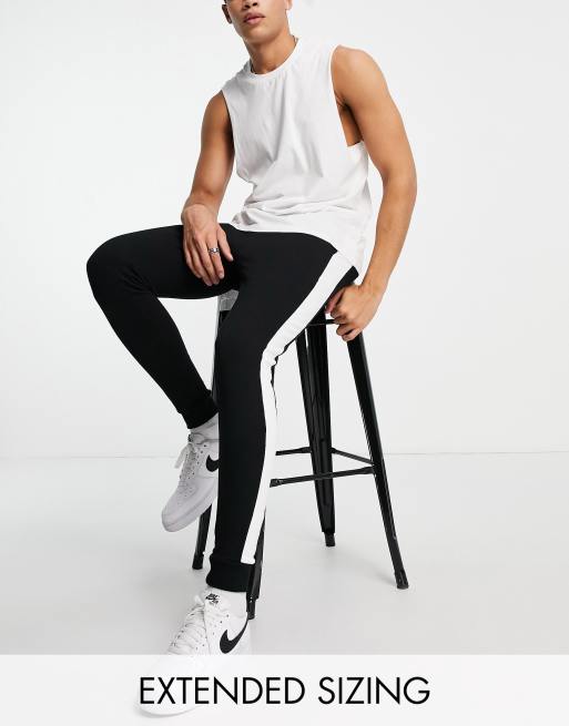 ASOS DESIGN skinny sweatpants with side stripe in black