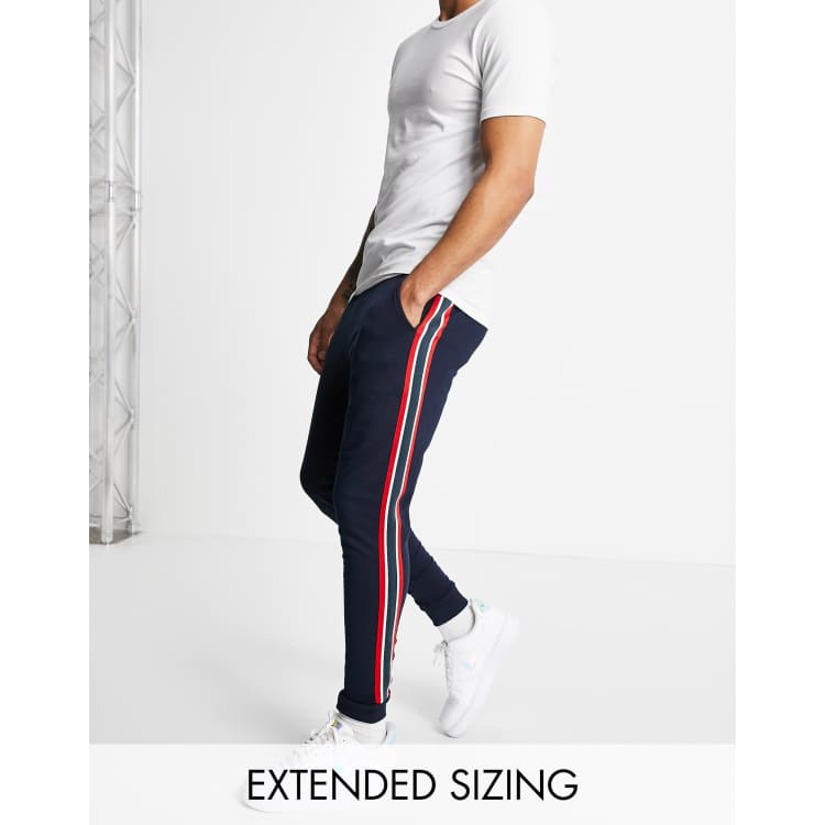 ASOS DESIGN skinny sweatpants with side stripe in navy ASOS