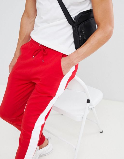 Skinny red joggers with red band, logo and zip