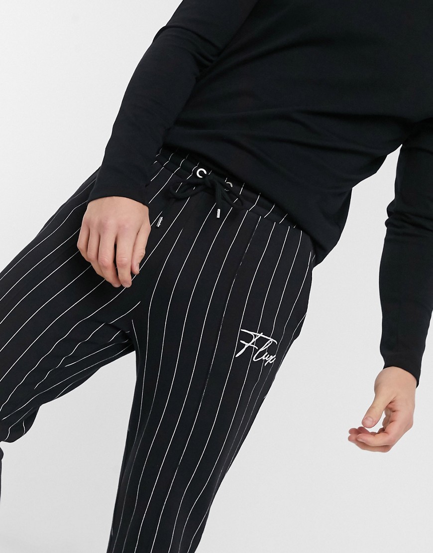 ASOS DESIGN skinny sweatpants with stripes and embroidered print in black