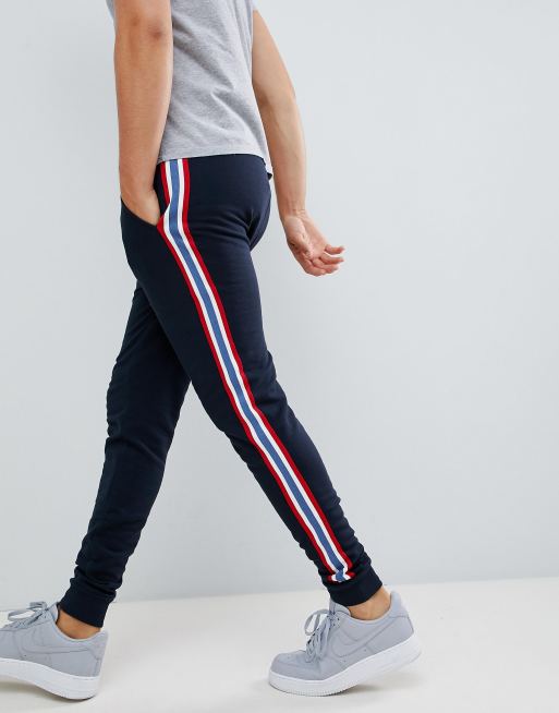 ASOS DESIGN skinny trackies with side stripe taping in navy | ASOS