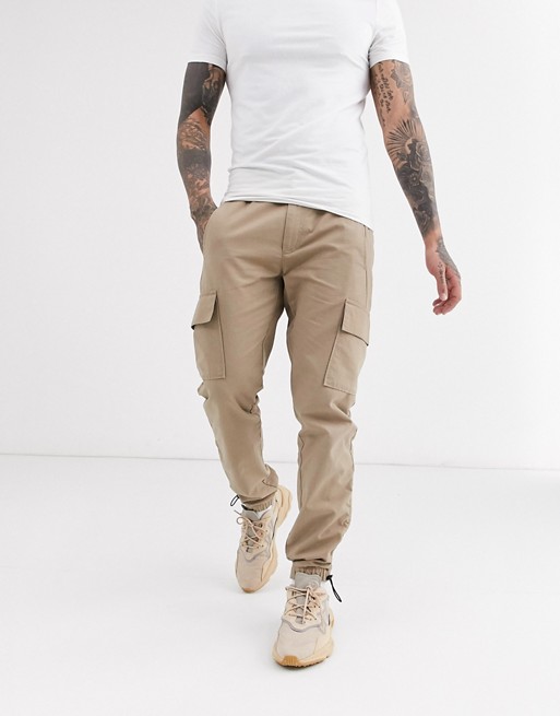 ASOS DESIGN slim cargo trousers with toggle hem in stone ripstop