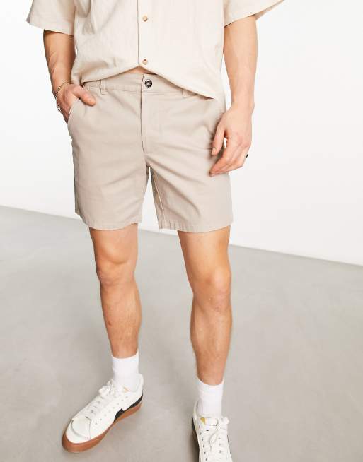 ASOS DESIGN pleated shorts in mid length in beige