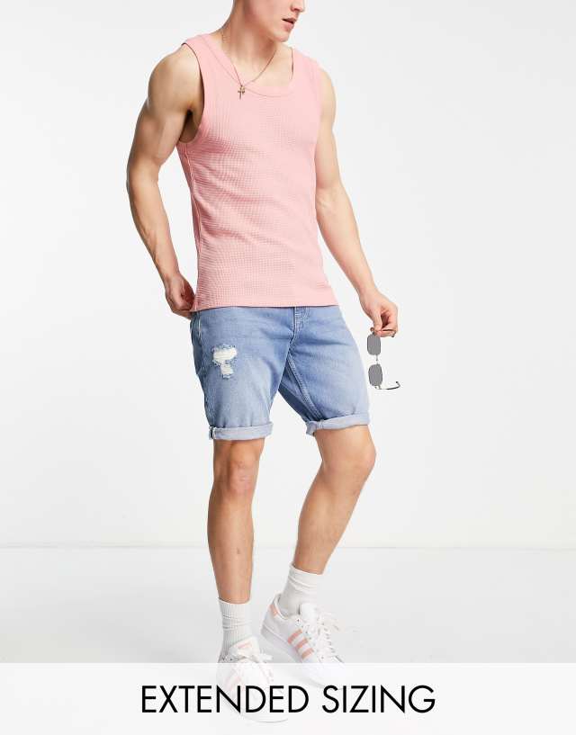 ASOS DESIGN slim denim shorts with abrasions in mid wash