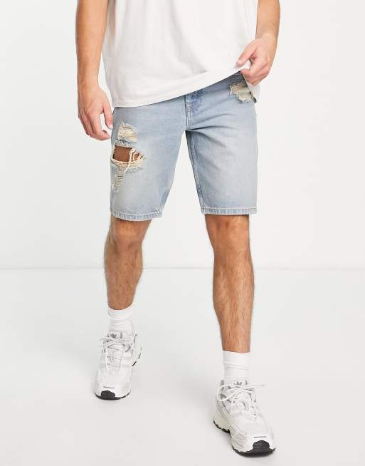 ASOS DESIGN slim denim shorts with heavy rips in tinted mid wash blue