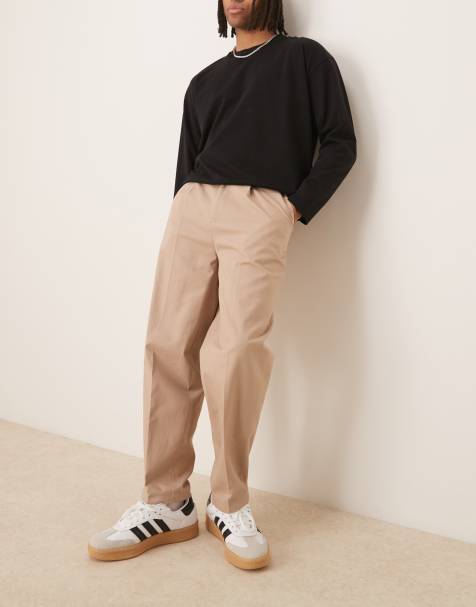 ASOS DESIGN - Slim-fit oversized toelopende chino broek van katoen met zijverstellers in licht stone - view 1